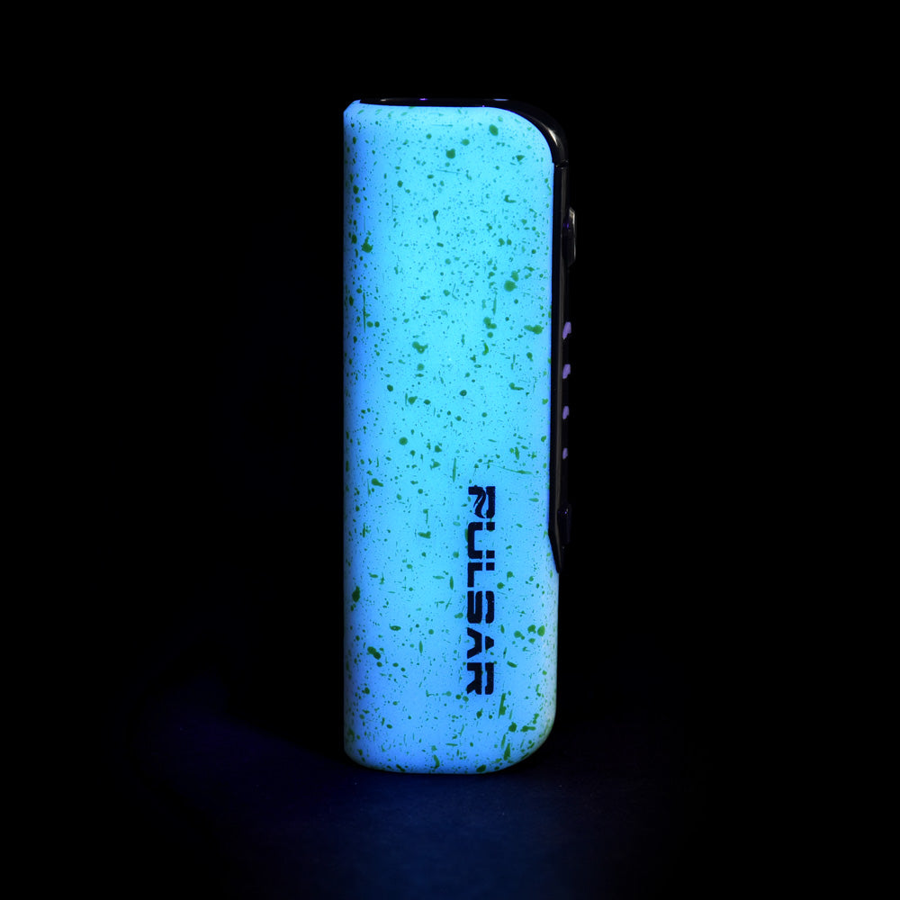 a lighter lit up in the dark with a black background