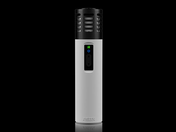 a white and black electric toothbrush on a black background