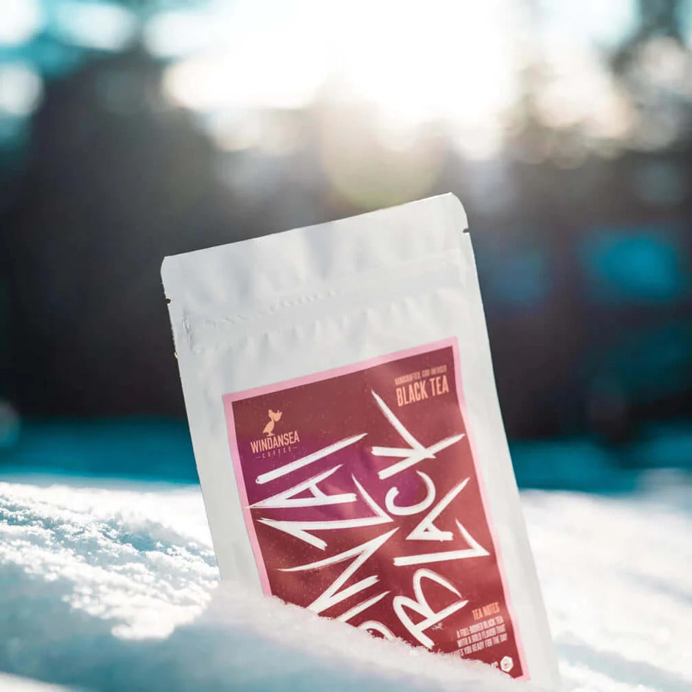 a packet of black tea sitting in the snow