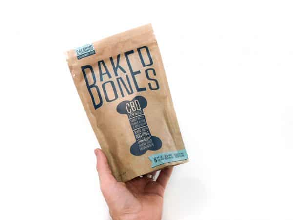 a hand holding a bag of baked bones