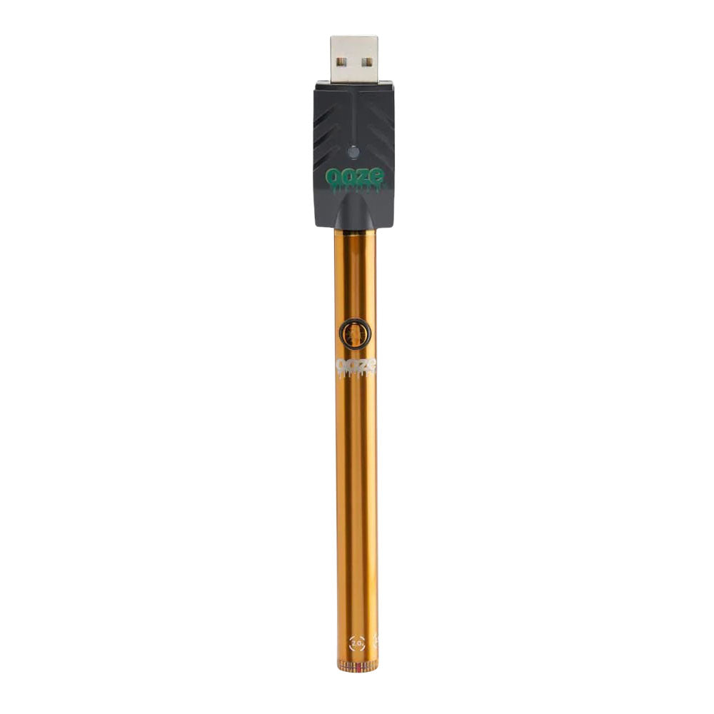 a gold metal pen with a green logo on it