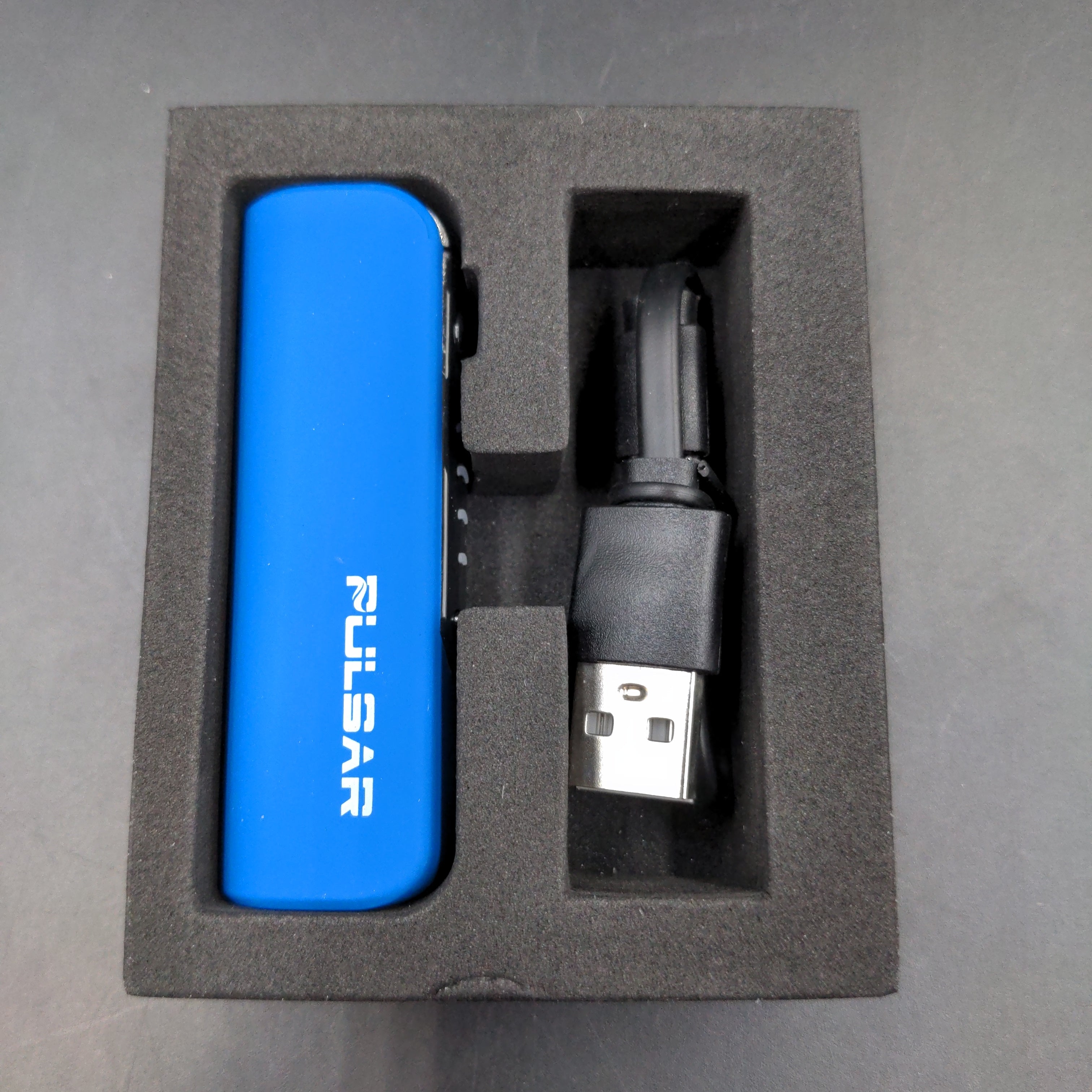 a blue lighter in a black box on a table