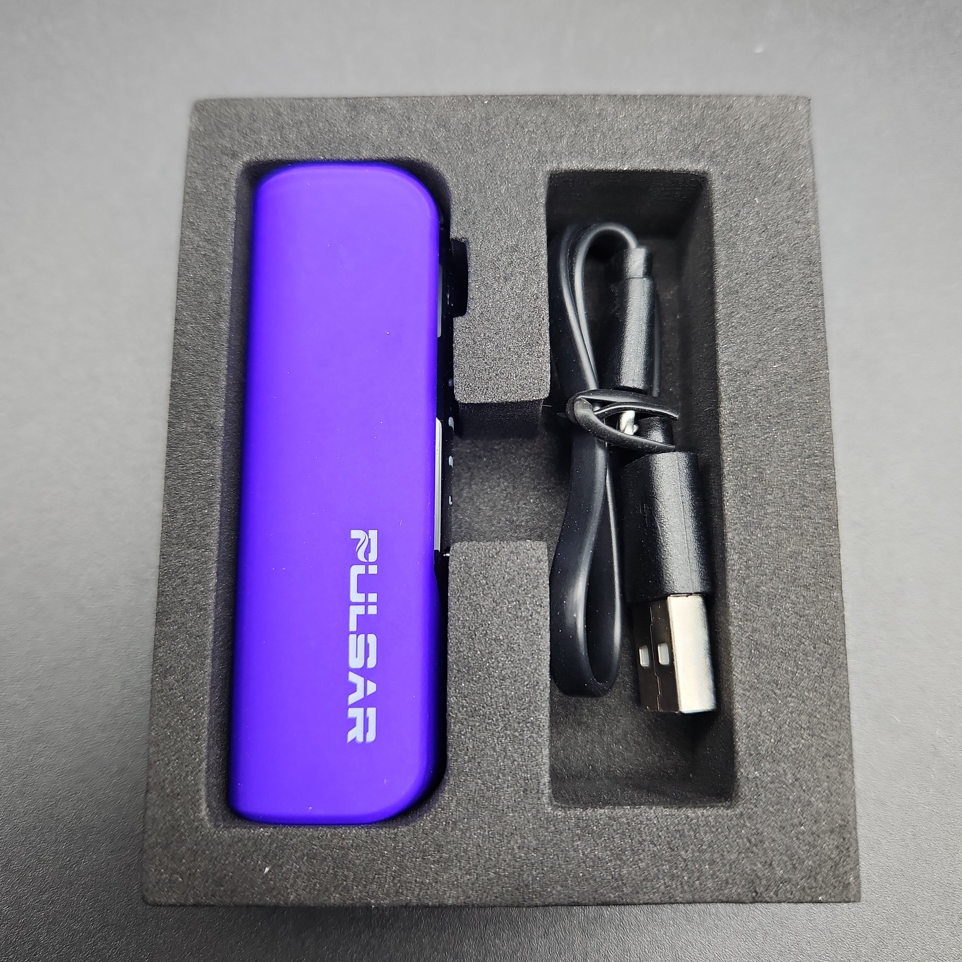 a purple lighter and charger in a box