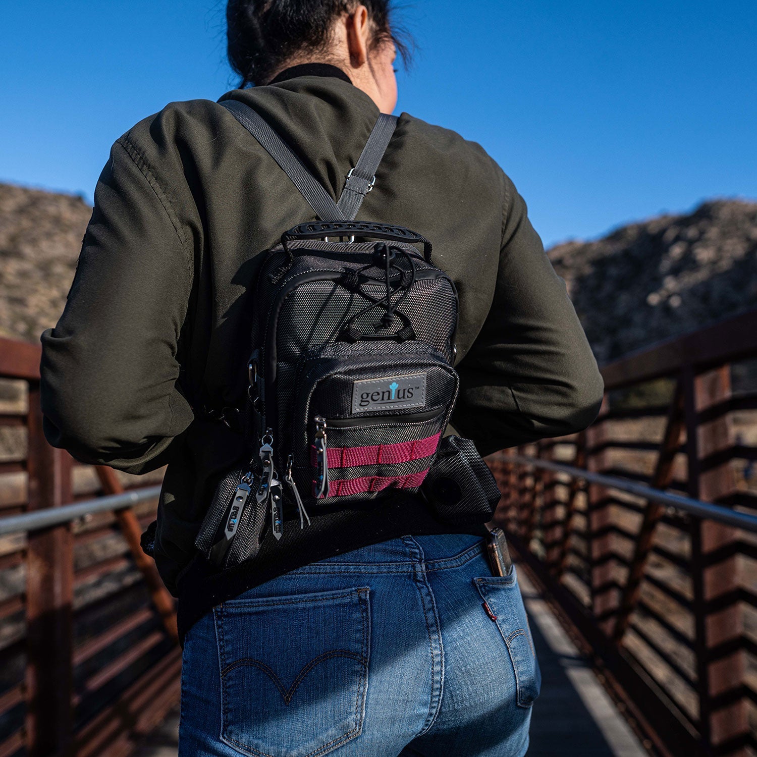 a person with a backpack walking across a bridge