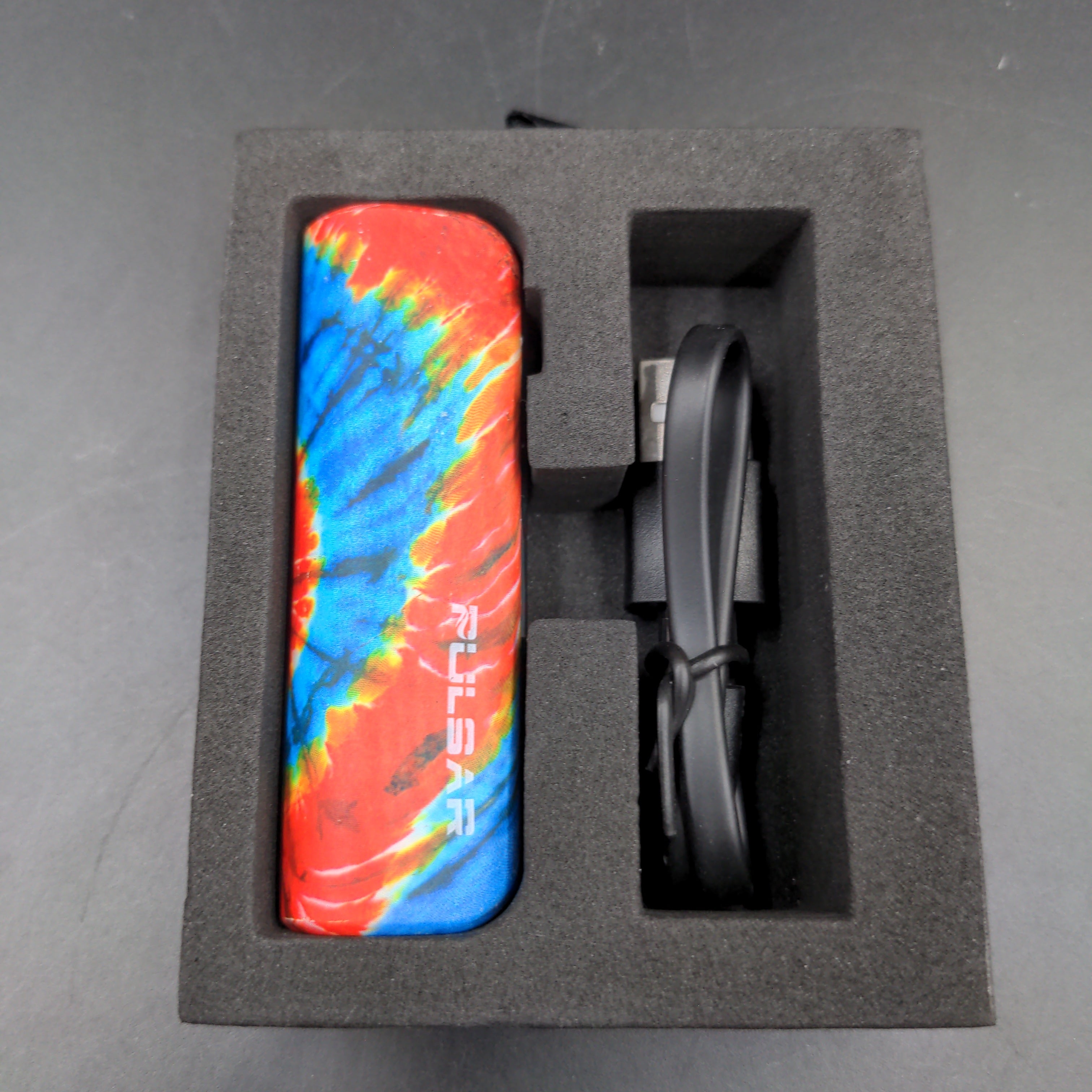 a tie - dyed lighter in a black box