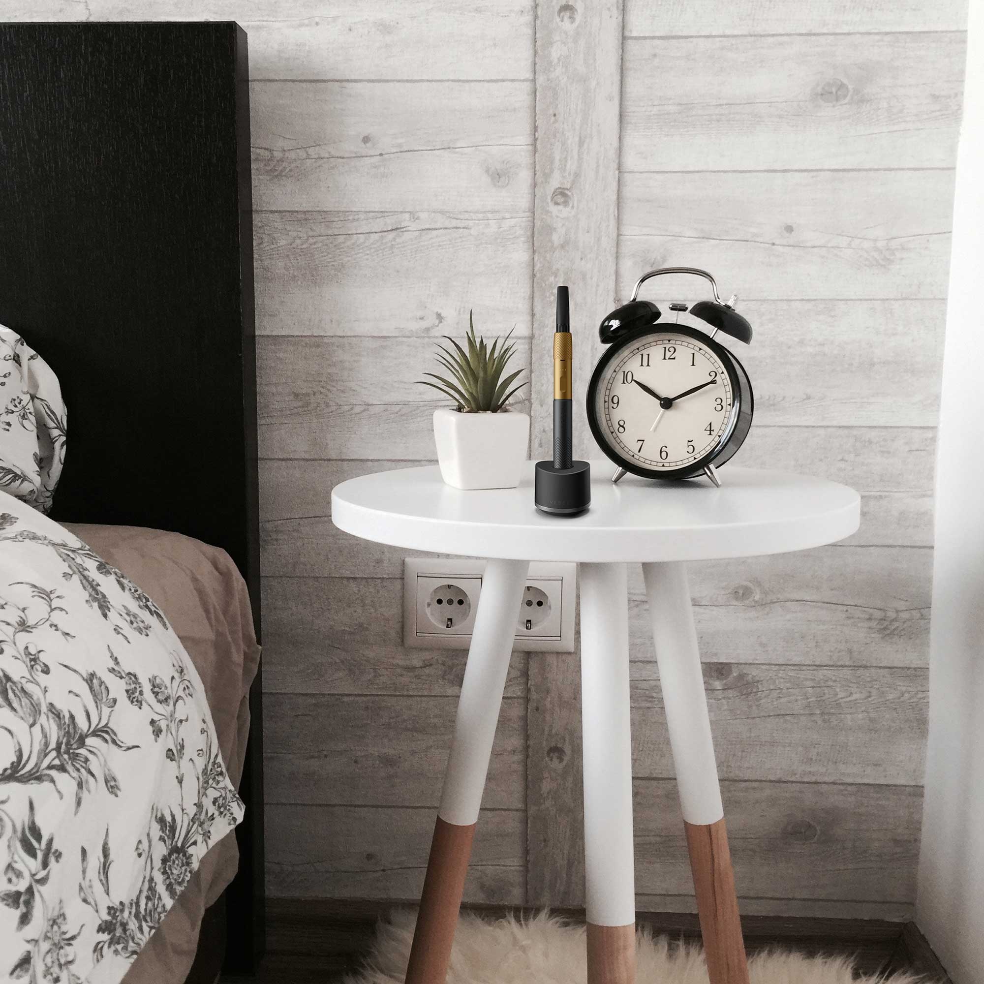 a small white table with a clock on top of it