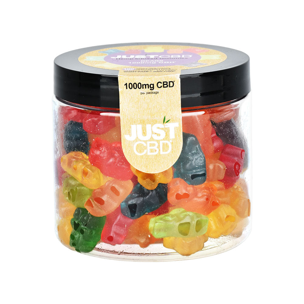 a jar filled with gummy bears sitting on top of a table