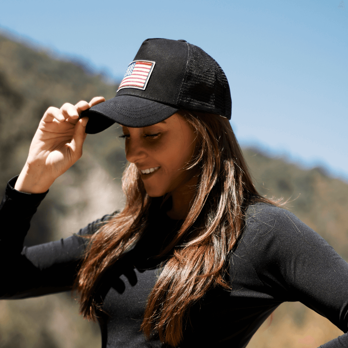 a woman in a black shirt and a black hat