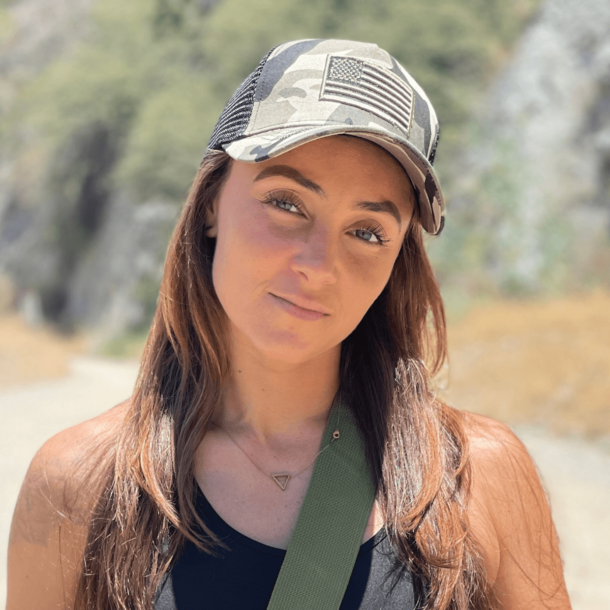 a woman wearing a hat and a green tie