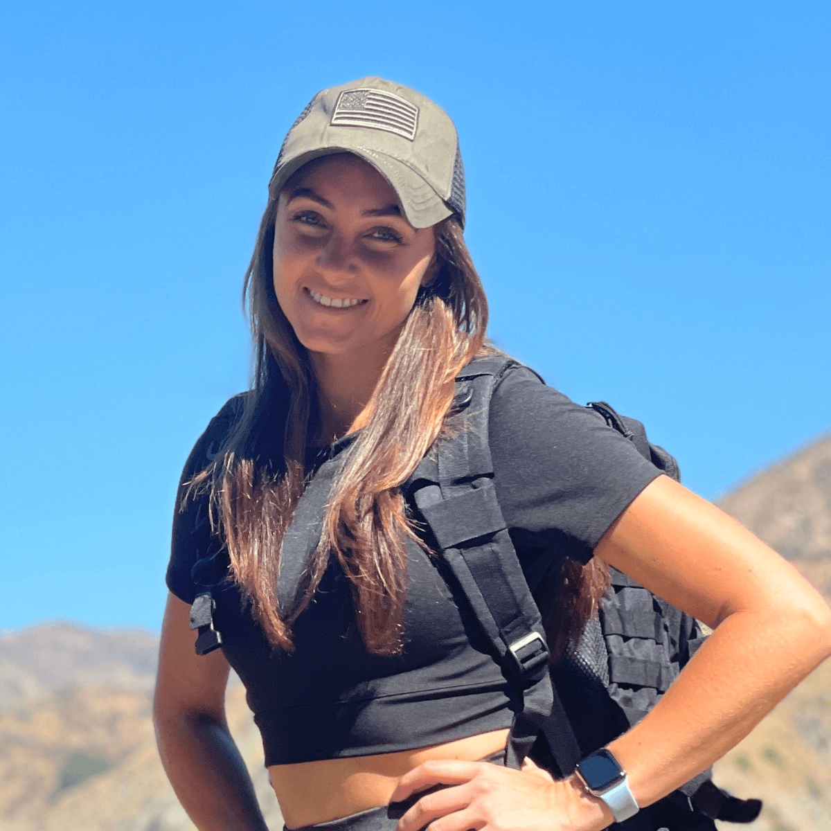 a woman wearing a hat and a black shirt