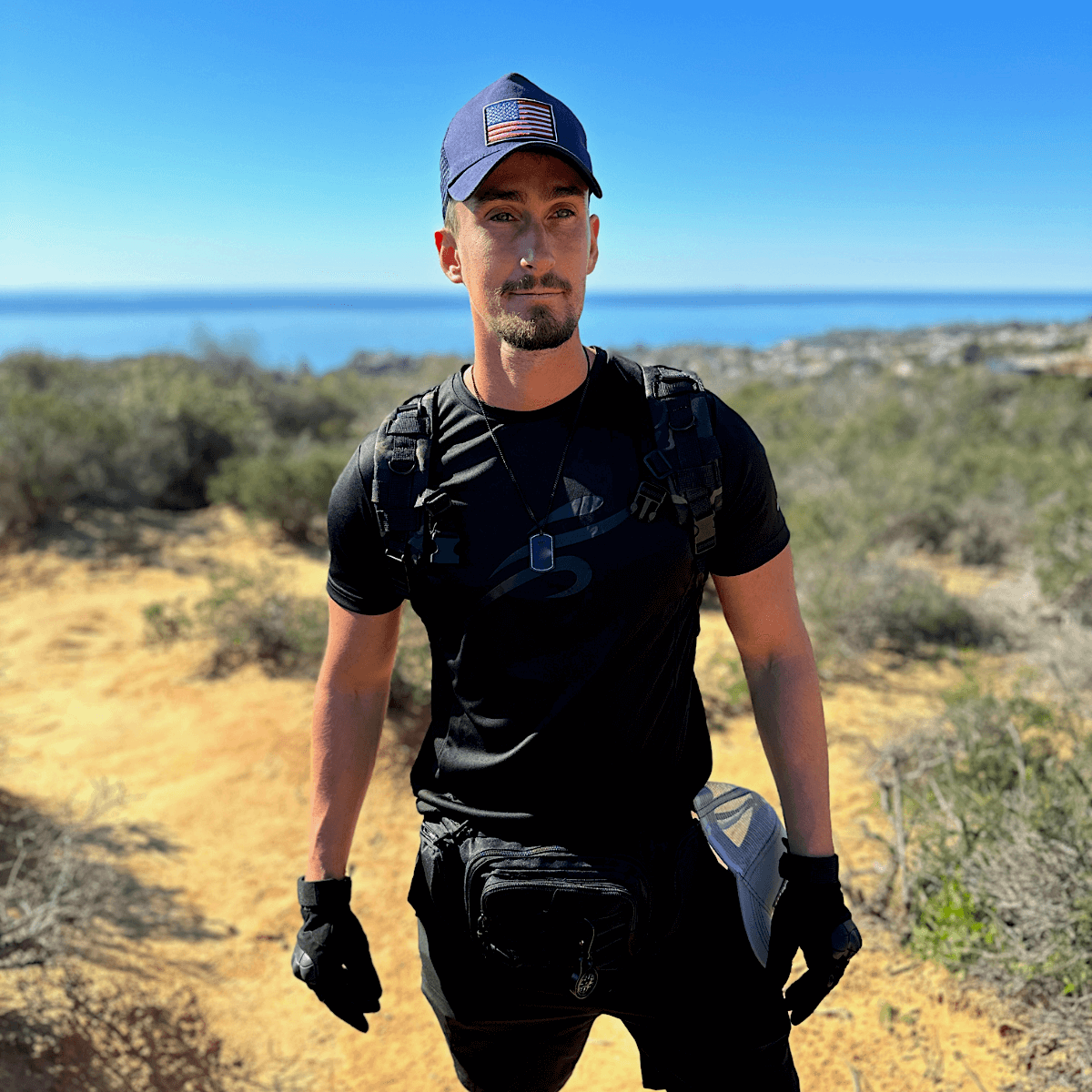 a man in a black shirt and a blue hat